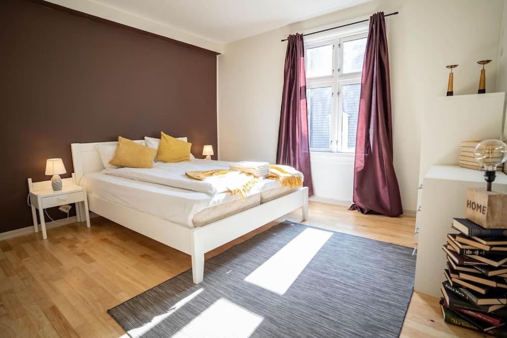 a bedroom with a white bed and a window at City Center Getaway - Stavanger BnB 6 by Berti in Stavanger