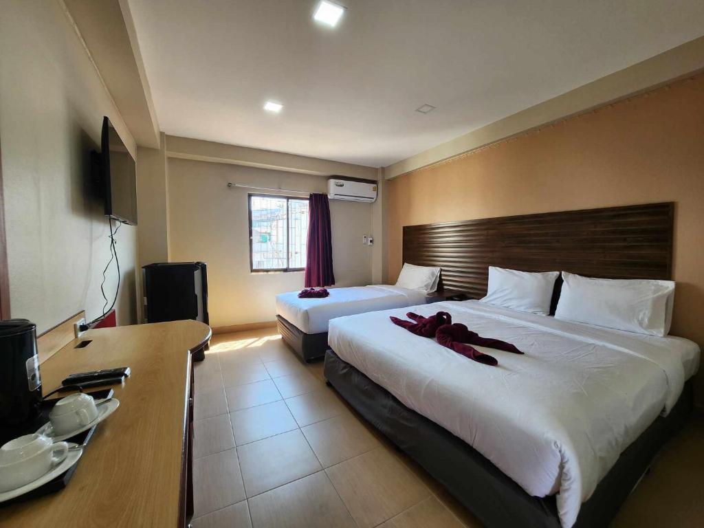 Postel nebo postele na pokoji v ubytování White Rose​ Hotel​ II​