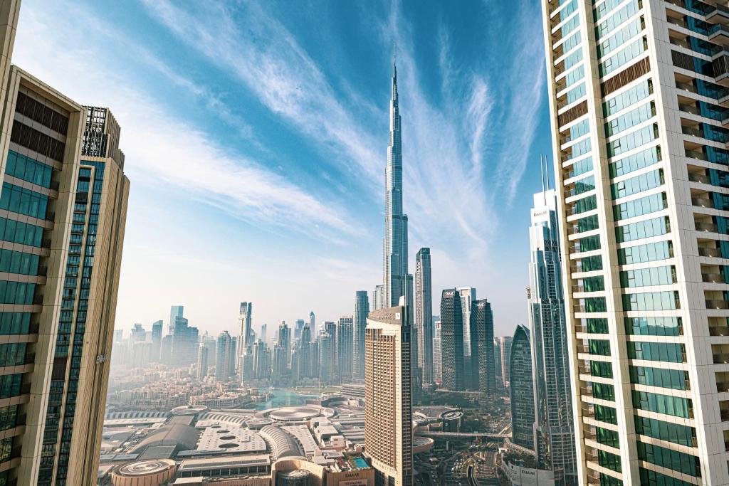 a view of a city with a tall skyscraper at SmartStay at Downtown Views - Best Burj Khalifa View - Brand New Luxury Apartments in Dubai
