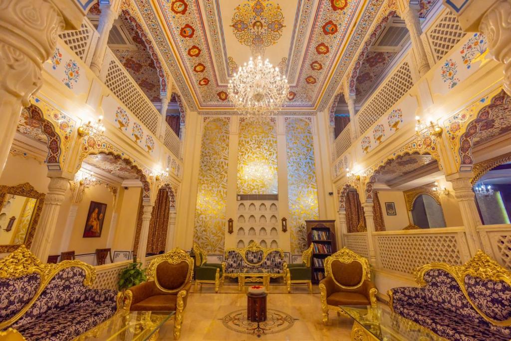 a large room with chairs and a chandelier at WelcomHeritage Traditional Haveli in Jaipur