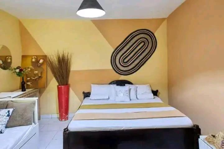 a bedroom with a large bed in a room at LOFTY DIANI STUDIO'S in Kwale