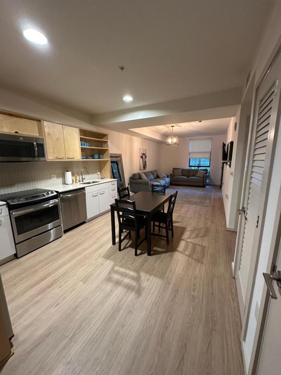 a kitchen and living room with a table and chairs at NOHO 1BR w Parking in Los Angeles