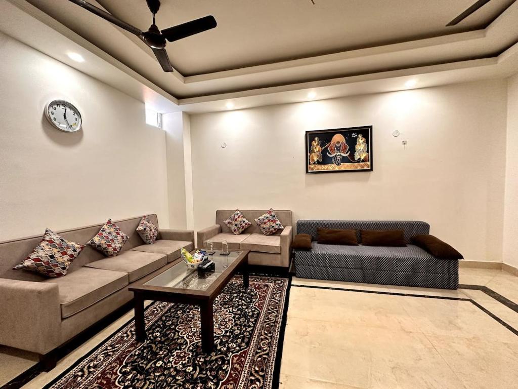 a living room with a couch and a table at Yoga Retreat at The Ganges in Rishikesh in Rishīkesh