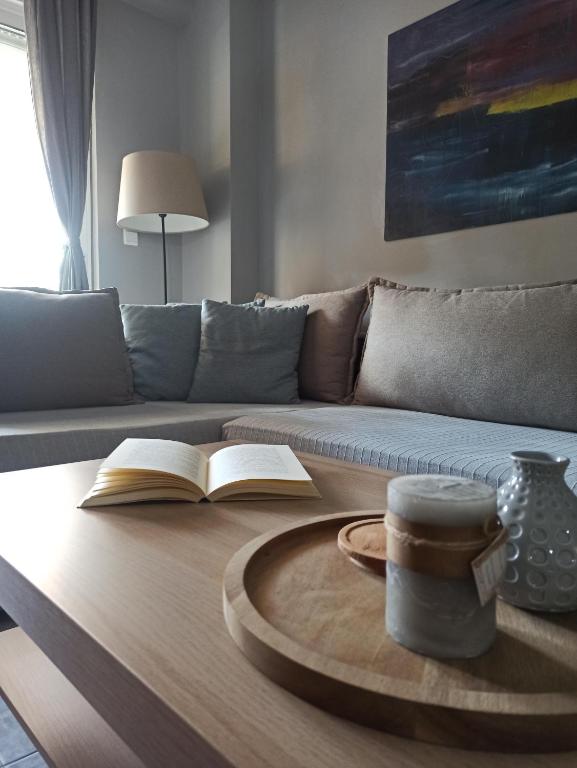 a coffee table with a book and a cup of coffee at Deluxe Lodge in Volos