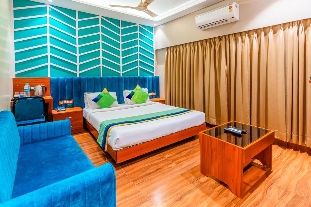 a hotel room with a bed and a couch at Treebo Trend Express Inn in Mumbai