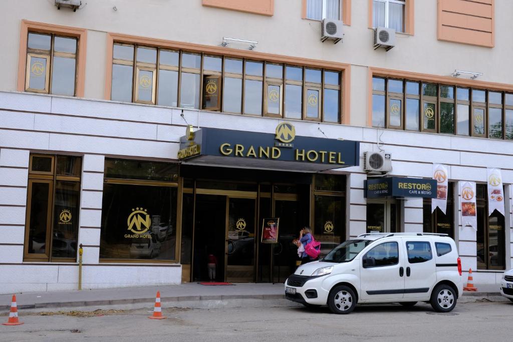 a white car parked in front of a grand hotel at ANGRAND HOTEL in Ankara