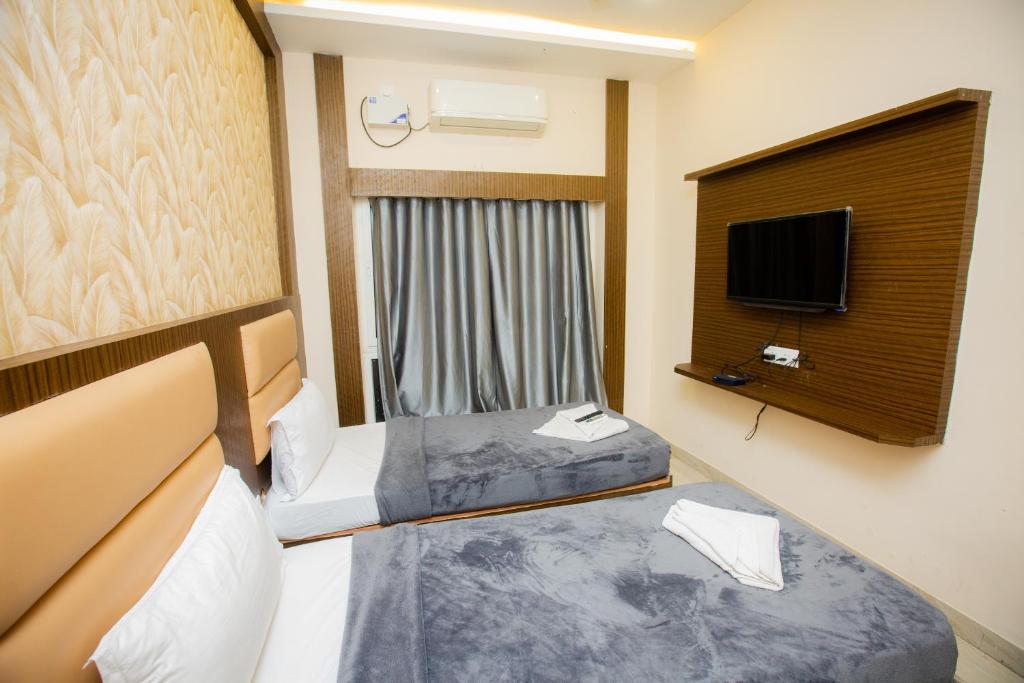 a hotel room with two beds and a tv at THE PARK AVENUE HOTEL - Business Class Hotel Near Central Railway Station Chennai Periyamet in Chennai