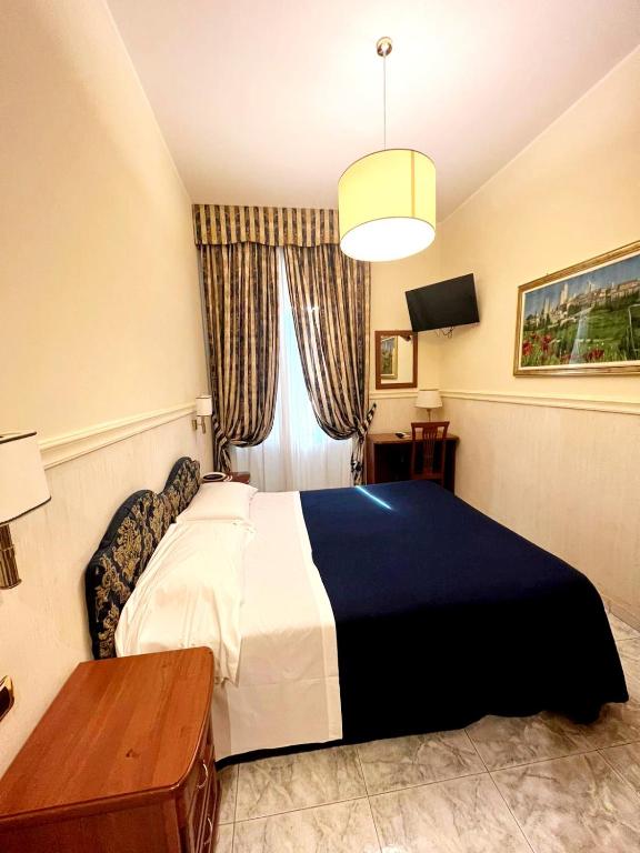 Postel nebo postele na pokoji v ubytování Hotel Mariano