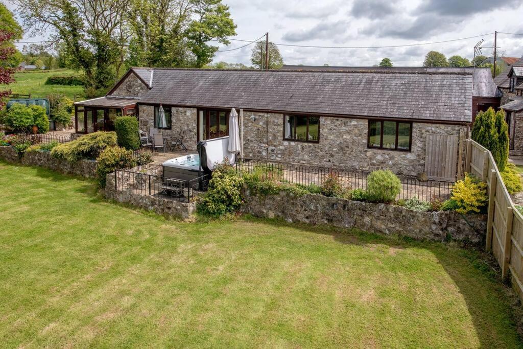an aerial view of a stone house with a yard at Holgates Cottage Countryside Retreat in Upottery