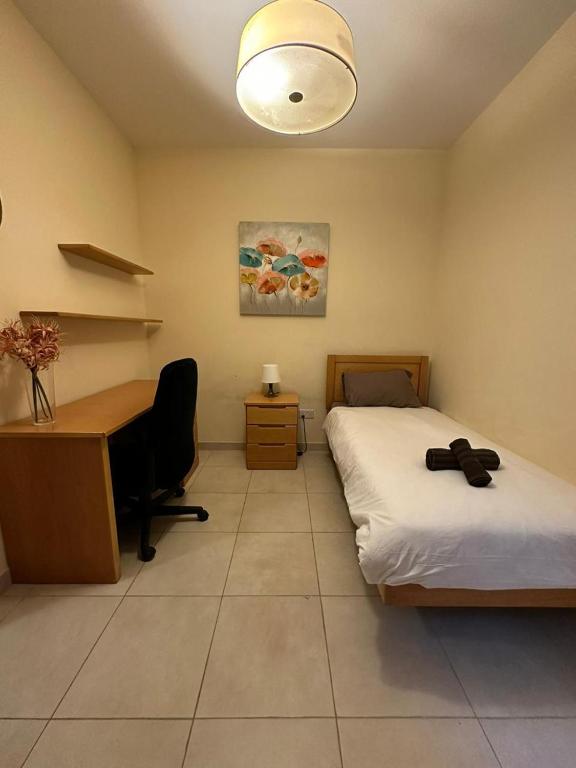 a bedroom with a desk and a bed and a desk and a computer at Cozy Room with Private Study in Taʼ Xbiex