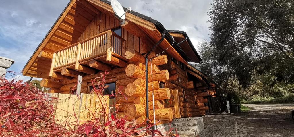 a log cabin with a balcony on the side of it at Kanadský zrub in Prievidza