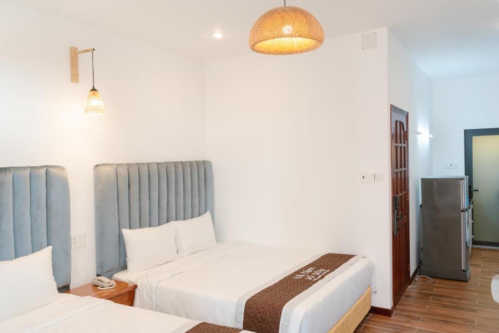 Postel nebo postele na pokoji v ubytování BA TAM VU SUA Homestay