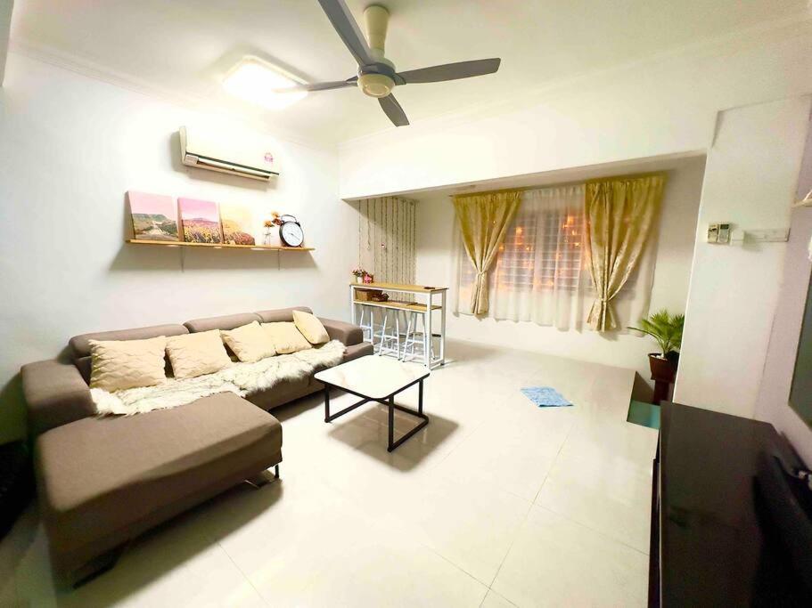 a living room with a couch and a ceiling fan at Free & Easy Leisure Homestay in Batu Caves