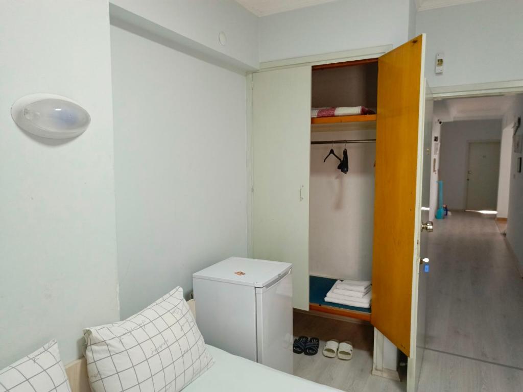 a small room with a bed and a small closet at Begumhan Pansiyon in Antalya