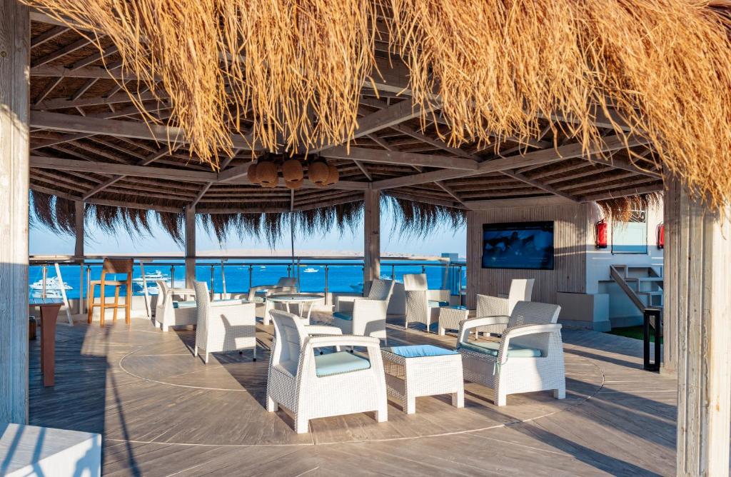 a restaurant with white chairs and a view of the ocean at Redcon Suites in Hurghada