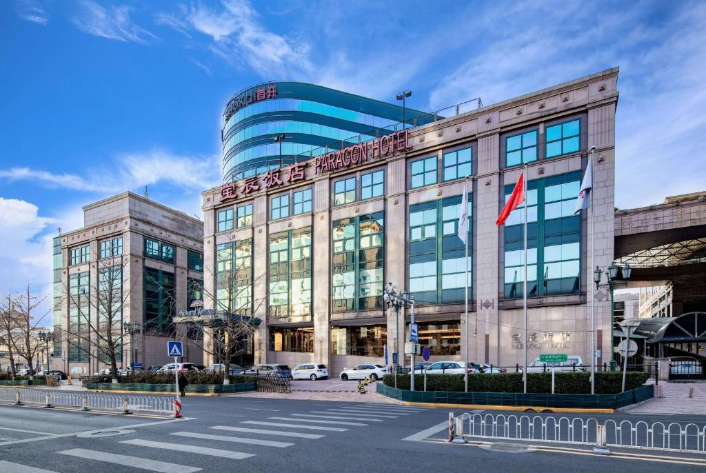 a building with a flag in front of it at Howard Johnson Paragon Hotel Beijing Central in Beijing