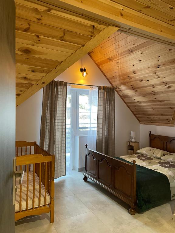 - une chambre avec un lit et un plafond en bois dans l'établissement Nad Potokiem, à Wapienne