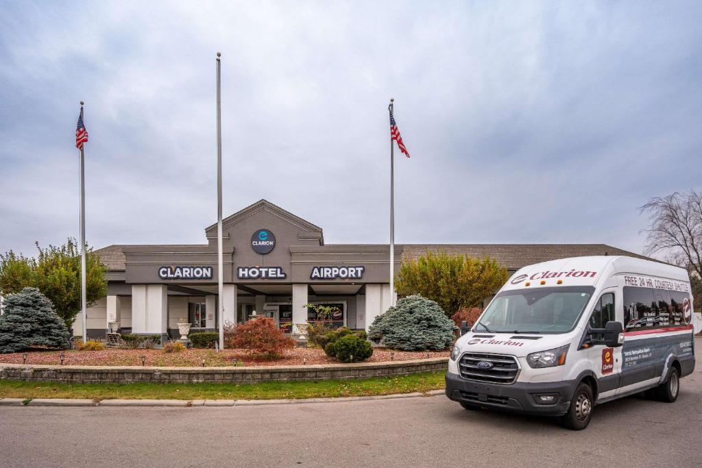 a white food truck parked in front of a store at Clarion Hotel Detroit Metro Airport in Romulus