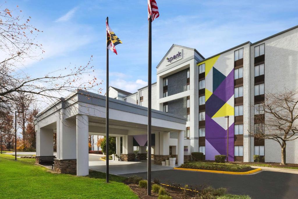 an office building with flags in front of it at Spark By Hilton Germantown Washington Dc North in Germantown