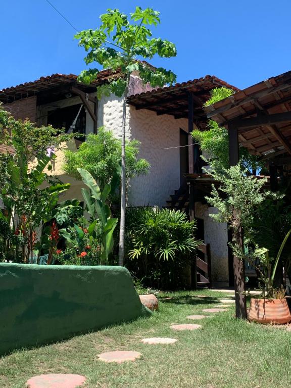 een tuin met een groene bank in de tuin bij Pousada Hostal das Estrelas in Praia do Frances