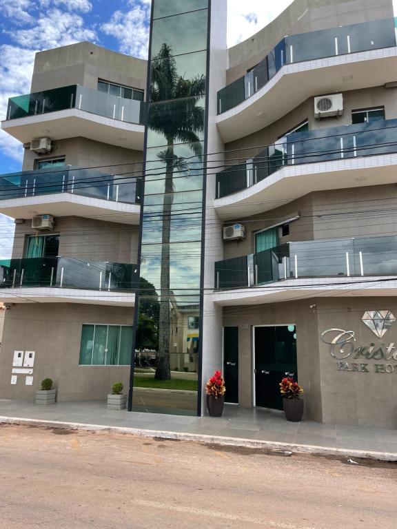 a reflection of a building with flowers in front of it at Cristal Park Hotel in Cristalina