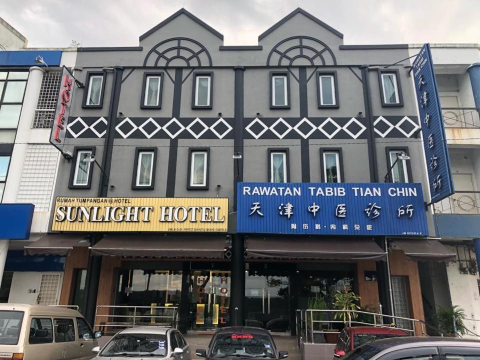 a building with a sign for a suntrust hotel at Sunlight Hotel Kulai in Kulai