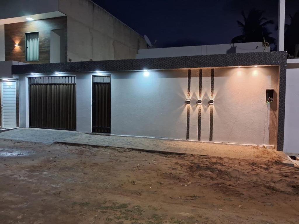 a house with a garage at night at VR Flats in Maragogi