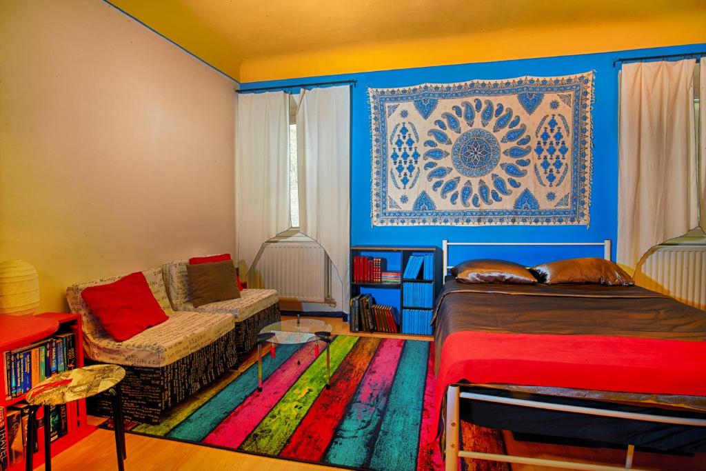 a living room with a couch and a rug at The Book Nest in Ljubljana