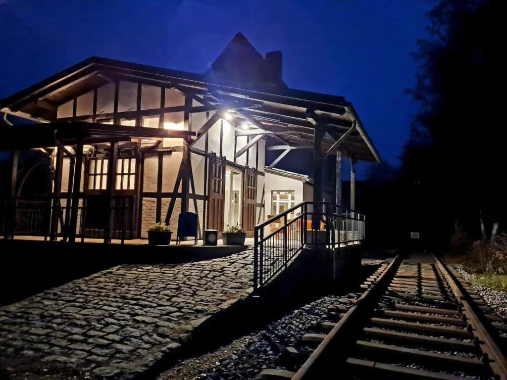 a train station at night with tracks in front of it at Museumsbahnhof Ahütte in Üxheim