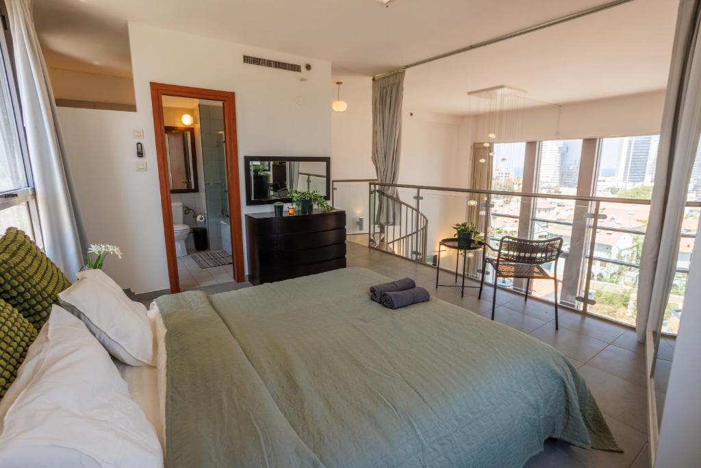 een slaapkamer met een bed en een balkon bij Neve Tsedek 2BR Apartment By Nimizz in Tel Aviv