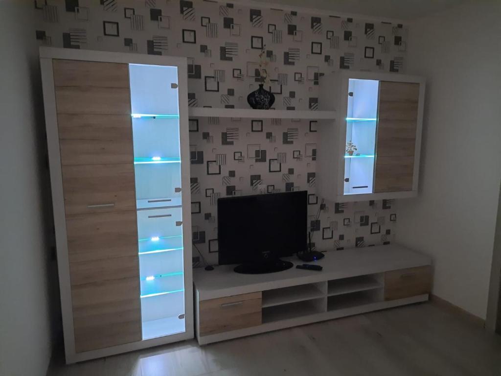 a living room with a television and a mirror at P Apartment in Rēzekne