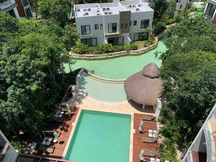 an overhead view of a swimming pool in front of a house at Beautiful apartment, Playa del Carmen, Jacuzzi in Playa del Carmen