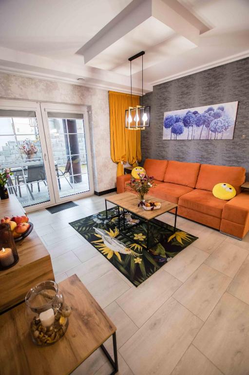 BukowinaApartments in Bukowina的客厅里有一张橙色的沙发和一张桌子