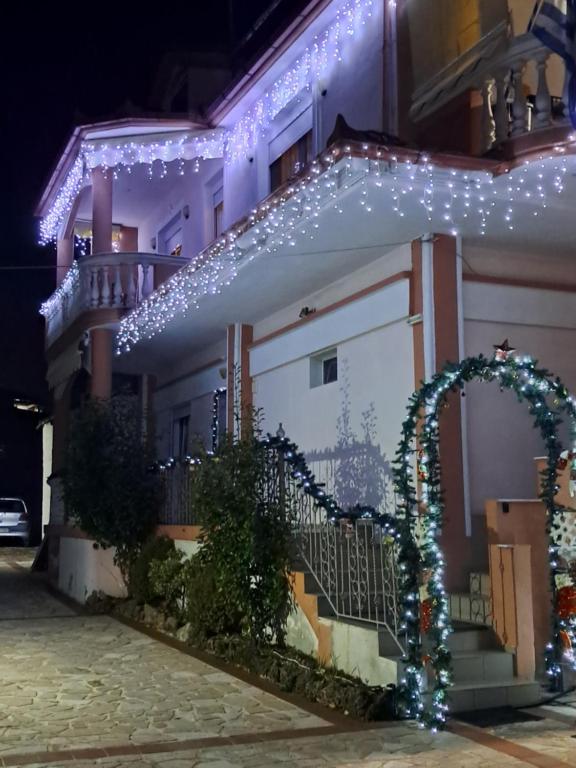 dom z lampkami świątecznymi na boku w obiekcie Erodios Guesthouse w mieście Kato Loutraki