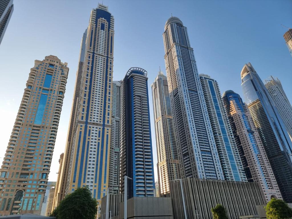 a group of tall buildings in a city at Granada Apartments Elite Residence in Dubai