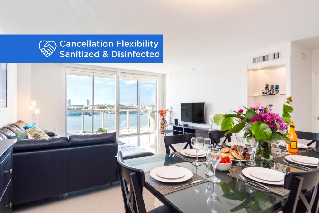 a living room with a table and a couch at Golden Bay 805 in Miami Beach