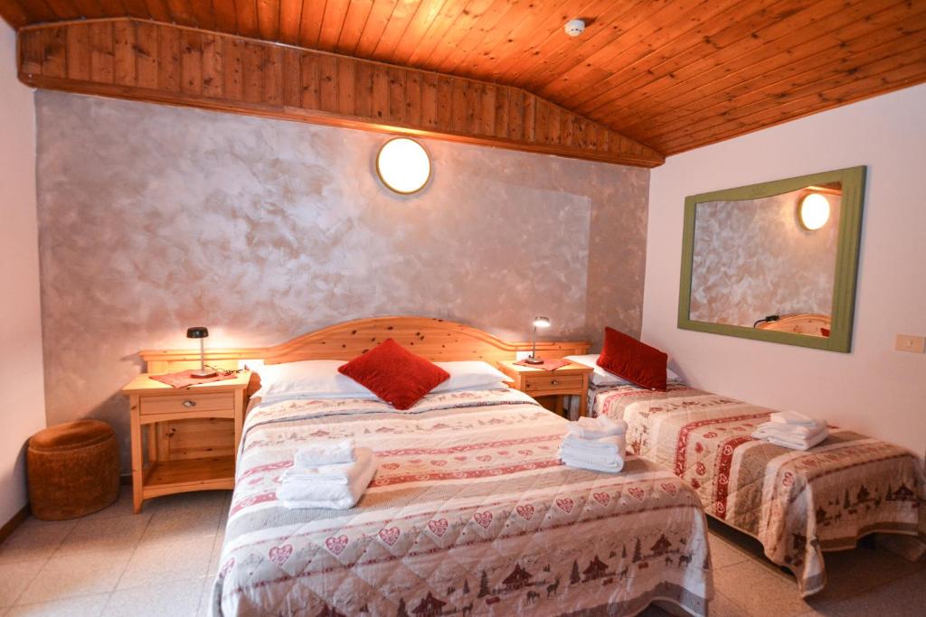 Postel nebo postele na pokoji v ubytování Hotel Cima d'Oro