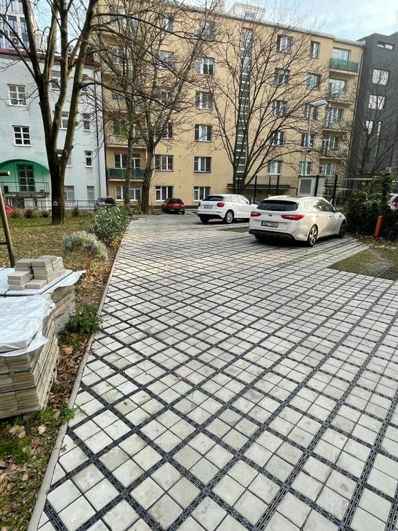 two cars parked in a parking lot next to a building at Luxury 2bed flat with free parking in Bratislava