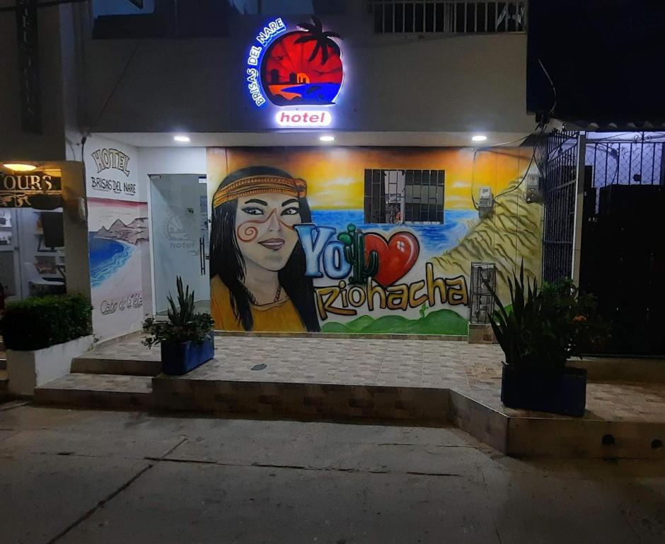 a building with a mural on the side of it at Hotel Brisas del Nare in Ríohacha