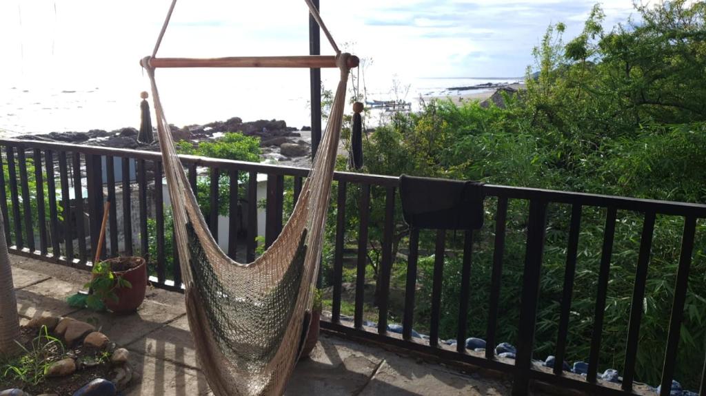 a hammock hanging from a fence on a balcony at Quinta Tisseaux in Casares