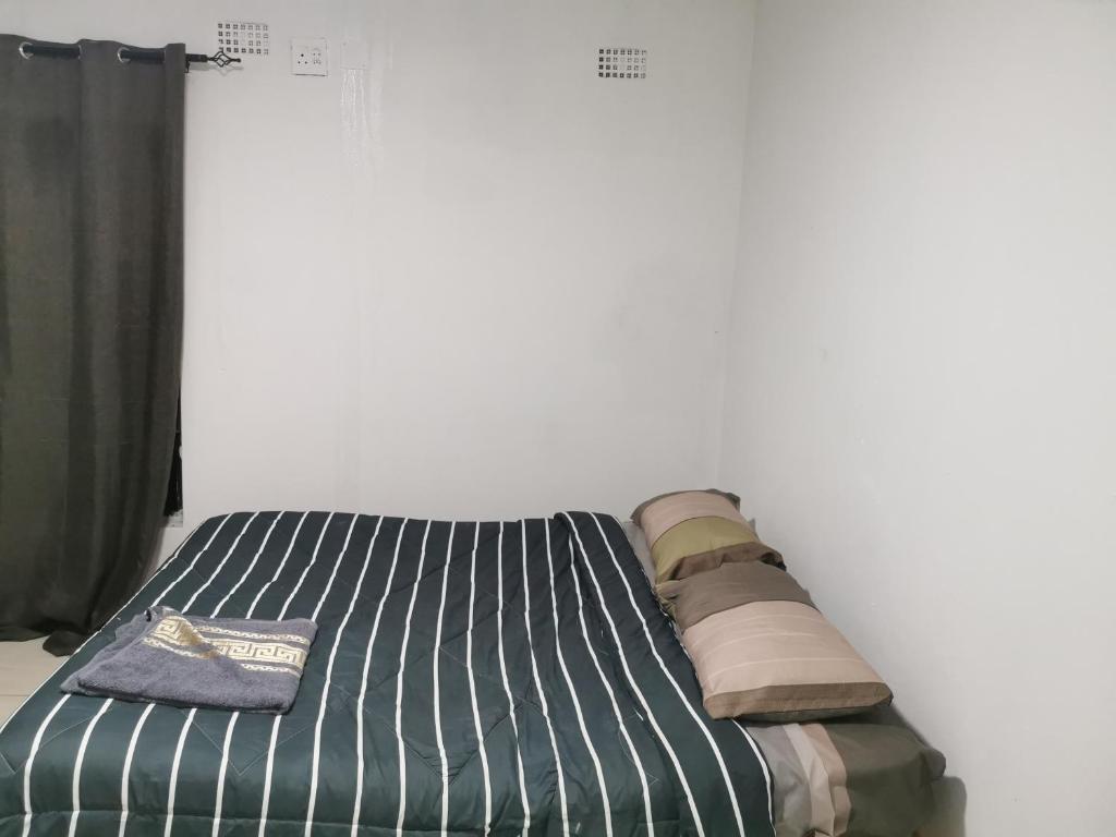 Bett mit Kissen darauf in einem Zimmer in der Unterkunft Northside beach lodge in Vilankulo