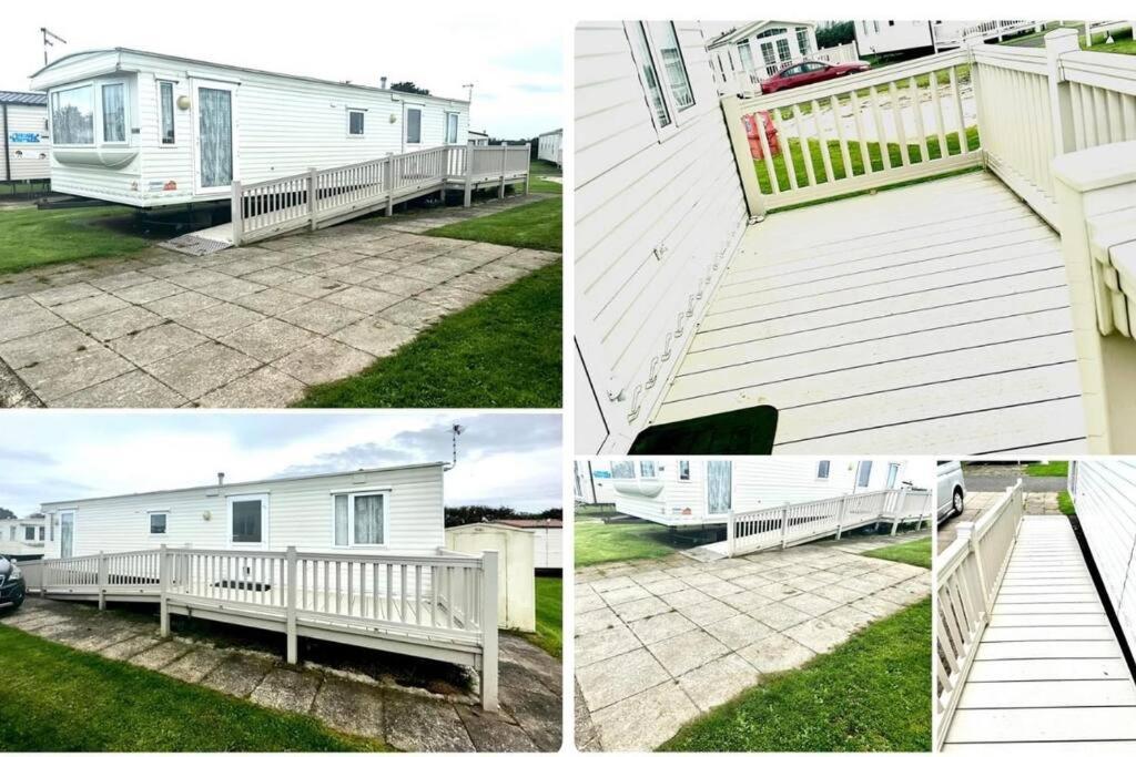 a white house with a porch and a deck at Withernsea Sands - Disabled friendly (maple grove) in Withernsea