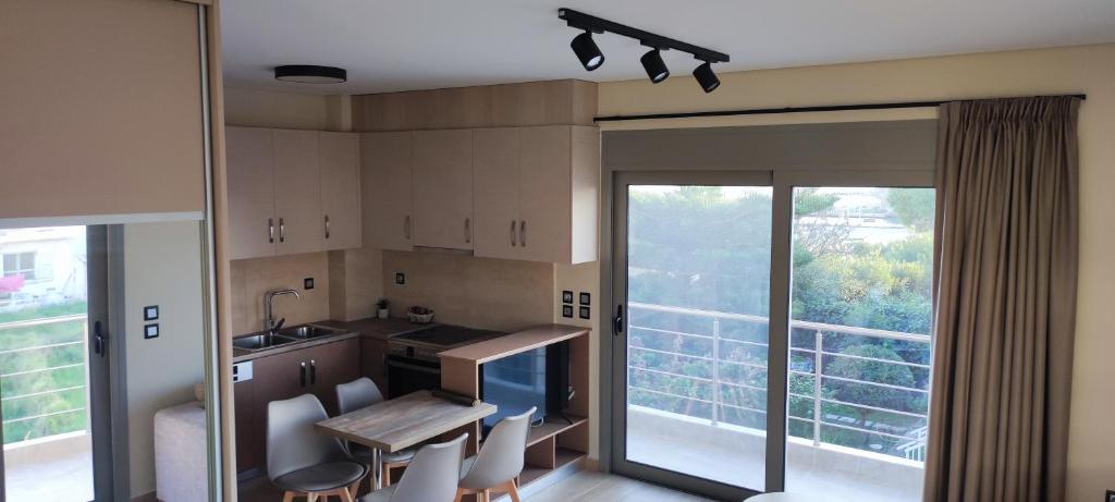 a kitchen with a table and chairs and a large window at Superior Bridge Apartment in Antirrio