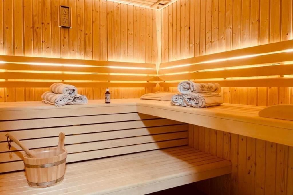 a sauna with towels and a basket of towels at Ferienhaus Die 12 mit 4 Schlafzimmern in Garmisch in Garmisch-Partenkirchen