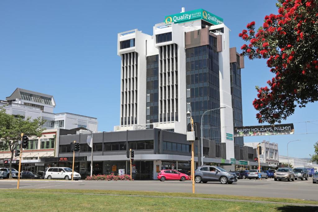 a building with a street sign on top of it at Quality Suites Central Square in Palmerston North