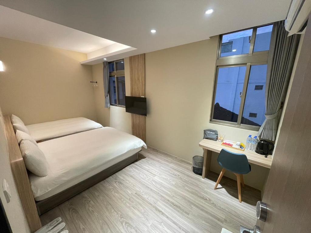 豐山村的住宿－順泰旅店 ，一间卧室配有一张床、一张书桌和一个窗户。