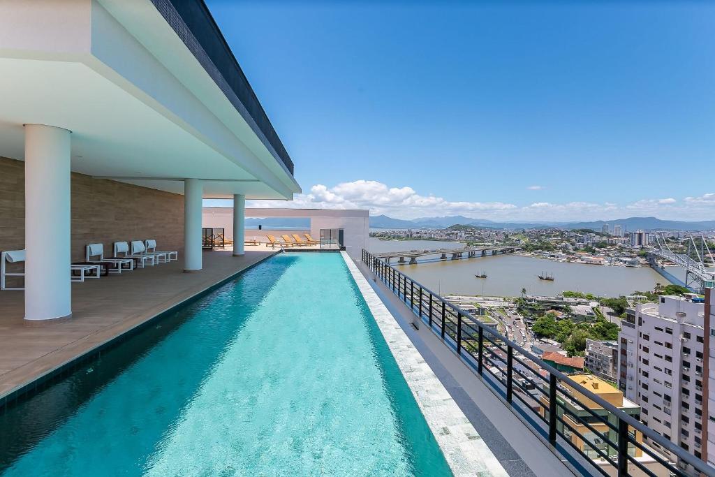 a swimming pool on the balcony of a building at Wi-FIi | 250MB | Sea View | Pool #CA60 in Florianópolis