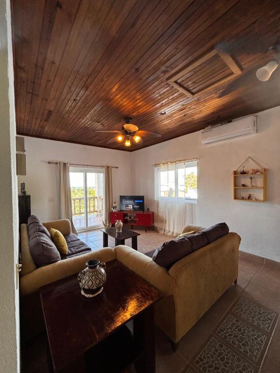 a living room with a couch and a table at Sunset Views Apartment, West End in West End