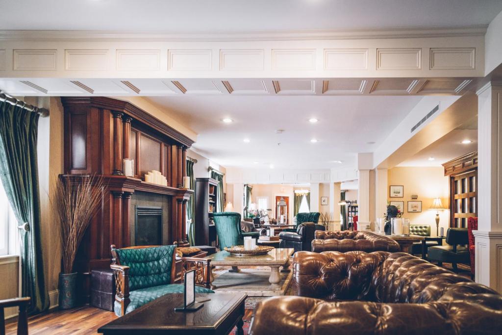 a living room with leather furniture and a fireplace at The Great George in Charlottetown