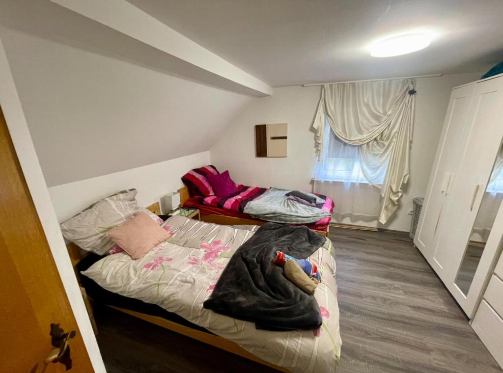 a bedroom with two beds and a window at double room for you in Hünxe